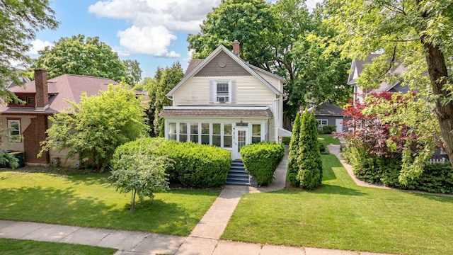 810 Glenwood Ave, Joliet, IL 60435 - view of front of house with a front yard and a chimney