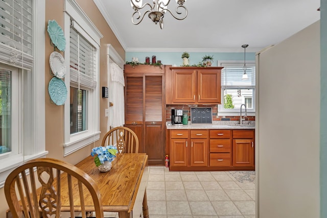 810 Glenwood Ave, Joliet, IL 60435 - kitchen featuring a chandelier, brown cabinetry, ornamental molding, light tile patterned floors, and hanging light fixtures