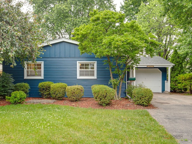 36586 N Traer Ter, Gurnee, IL 60031 - view of front facade featuring asphalt driveway, an attached garage, board and batten siding, and a front yard