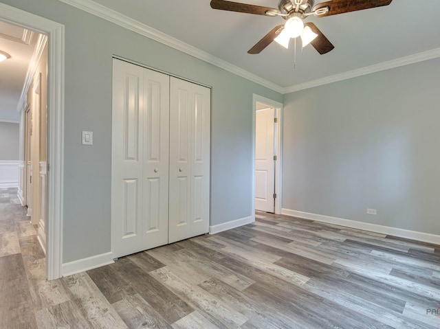 36586 N Traer Ter, Gurnee, IL 60031 - unfurnished bedroom featuring crown molding, wood finished floors, a closet, and a ceiling fan