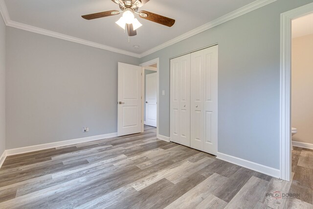 36586 N Traer Ter, Gurnee, IL 60031 - unfurnished bedroom featuring wood finished floors, ornamental molding, a closet, and ceiling fan