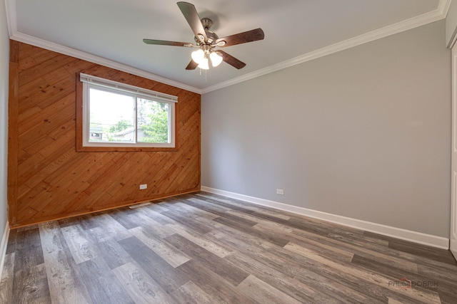 36586 N Traer Ter, Gurnee, IL 60031 - spare room with a ceiling fan, wood walls, wood finished floors, and crown molding