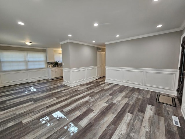 36586 N Traer Ter, Gurnee, IL 60031 - empty room featuring crown molding, a wainscoted wall, recessed lighting, dark wood-style floors, and a decorative wall