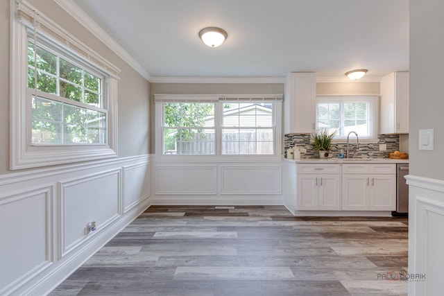 36586 N Traer Ter, Gurnee, IL 60031 - unfurnished dining area with ornamental molding, light wood finished floors, a decorative wall, and wainscoting