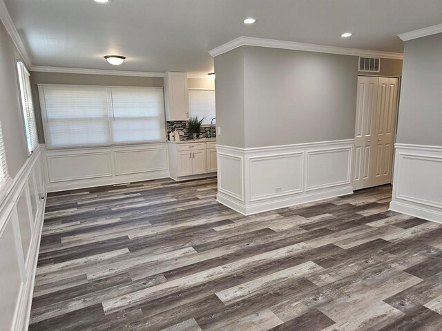 36586 N Traer Ter, Gurnee, IL 60031 - unfurnished dining area featuring recessed lighting, dark wood-type flooring, a decorative wall, a wainscoted wall, and ornamental molding