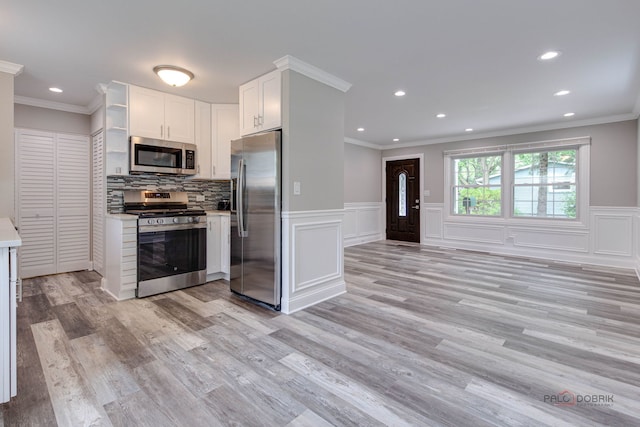 36586 N Traer Ter, Gurnee, IL 60031 - kitchen with appliances with stainless steel finishes, ornamental molding, white cabinets, recessed lighting, and light countertops