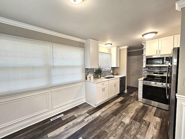 36586 N Traer Ter, Gurnee, IL 60031 - kitchen with appliances with stainless steel finishes, a sink, ornamental molding, white cabinets, and light countertops