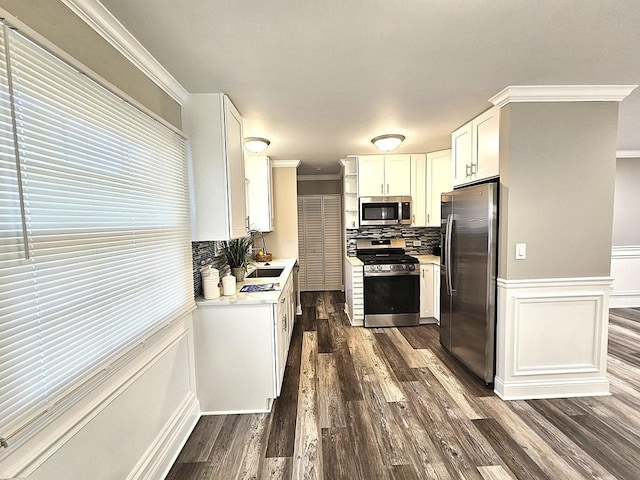 36586 N Traer Ter, Gurnee, IL 60031 - kitchen with stainless steel appliances, crown molding, light countertops, dark wood finished floors, and white cabinetry