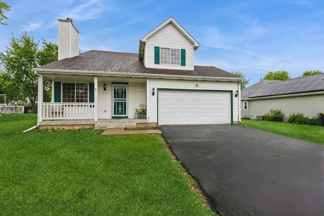 1714 Daybreak Ln, Zion, IL 60099 - view of front facade featuring covered porch, driveway, a front yard, an attached garage, and a chimney