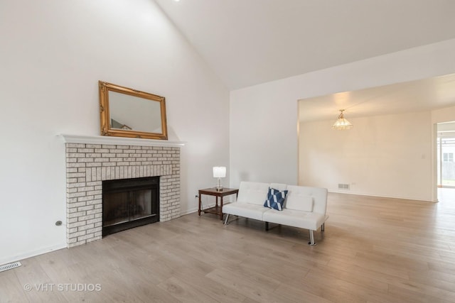 1714 Daybreak Ln, Zion, IL 60099 - sitting room featuring wood finished floors, a brick fireplace, and high vaulted ceiling