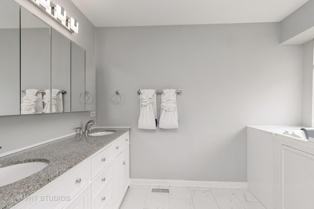 1714 Daybreak Ln, Zion, IL 60099 - bathroom with double vanity, marble look tiles, and baseboards