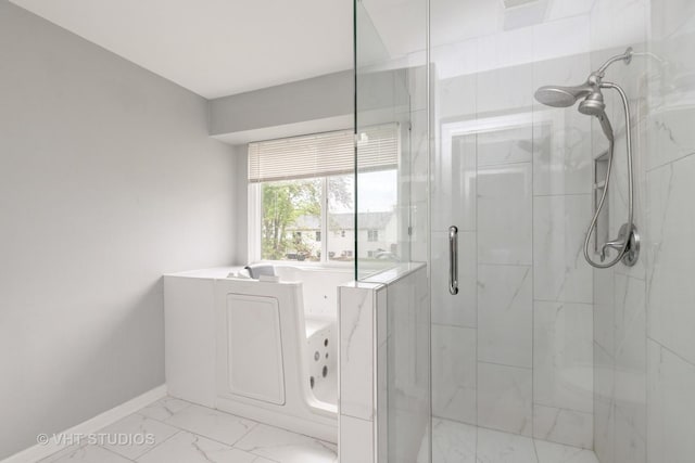 1714 Daybreak Ln, Zion, IL 60099 - bathroom with a marble finish shower, a bath, marble look tiles, baseboards, and washer / clothes dryer