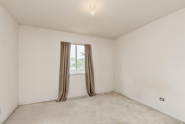 1714 Daybreak Ln, Zion, IL 60099 - unfurnished room with baseboards and light colored carpet