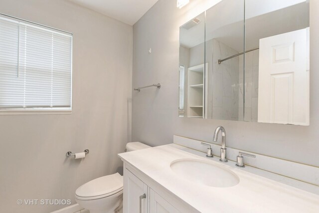 1714 Daybreak Ln, Zion, IL 60099 - bathroom featuring vanity, toilet, and a shower