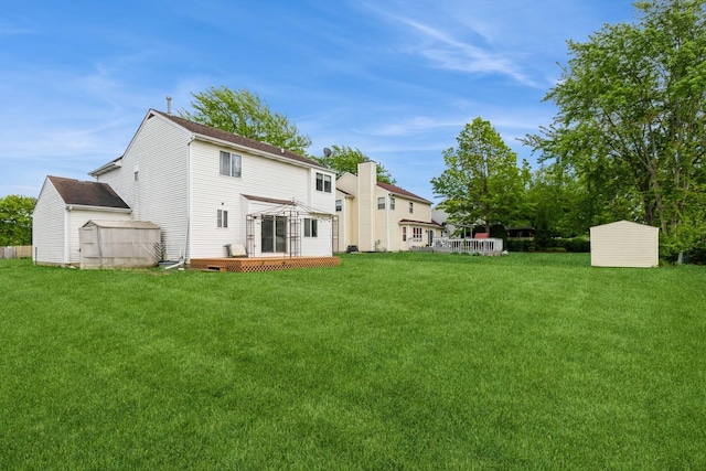 1714 Daybreak Ln, Zion, IL 60099 - back of house featuring a yard, a wooden deck, and a chimney