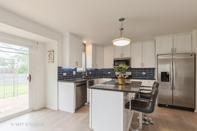 1714 Daybreak Ln, Zion, IL 60099 - kitchen featuring appliances with stainless steel finishes, backsplash, light wood-type flooring, white cabinets, and a sink