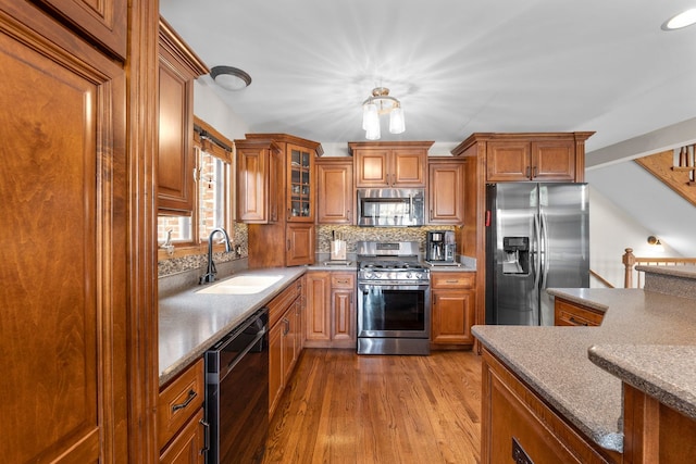 373 W Joliet Hwy, New Lenox, IL 60451 - kitchen with stainless steel appliances, brown cabinets, wood finished floors, and decorative backsplash
