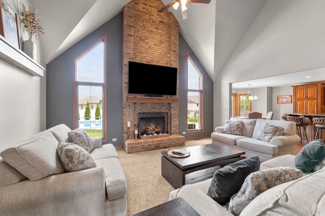 373 W Joliet Hwy, New Lenox, IL 60451 - carpeted living room with high vaulted ceiling, a ceiling fan, a fireplace, and a chandelier