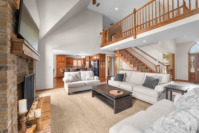 373 W Joliet Hwy, New Lenox, IL 60451 - living room with light carpet, stairs, high vaulted ceiling, a brick fireplace, and recessed lighting