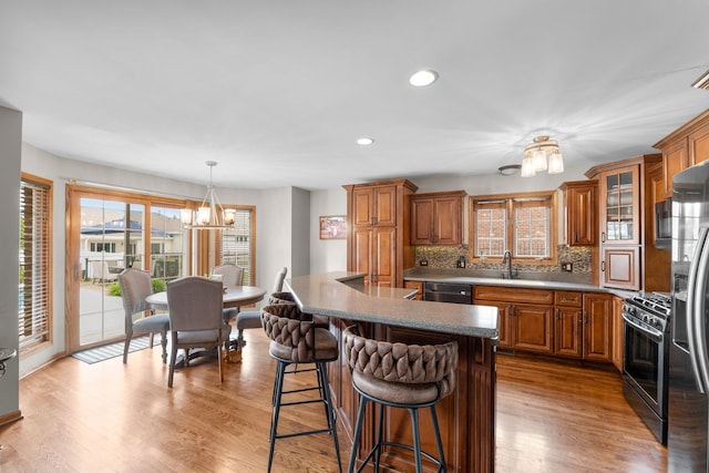 373 W Joliet Hwy, New Lenox, IL 60451 - kitchen with appliances with stainless steel finishes, a chandelier, brown cabinetry, backsplash, and recessed lighting