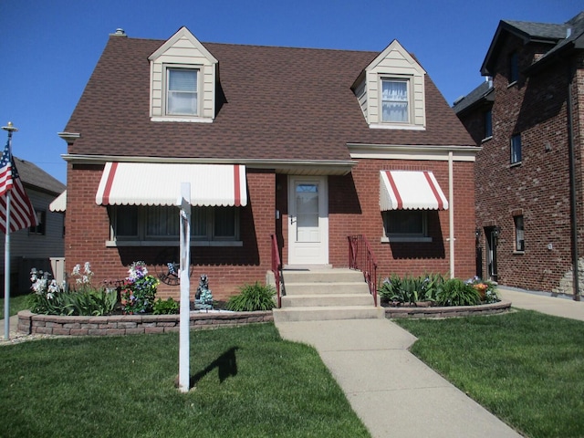 10918 S Ridgeway Ave, Chicago, IL 60655 - new england style home featuring brick siding, a front yard, entry steps, and roof with shingles