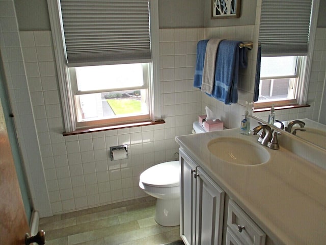 10918 S Ridgeway Ave, Chicago, IL 60655 - bathroom with tile walls, toilet, vanity, and healthy amount of natural light