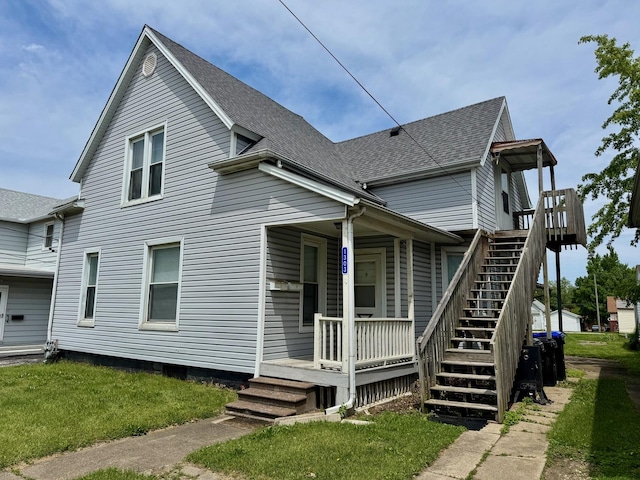 1303 W Locust St, Bloomington, IL 61701 - view of property exterior featuring a porch, a shingled roof, a lawn, and stairs
