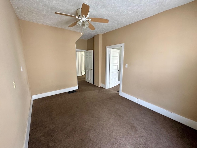 1303 W Locust St, Bloomington, IL 61701 - empty room featuring ceiling fan, a textured ceiling, baseboards, and dark carpet