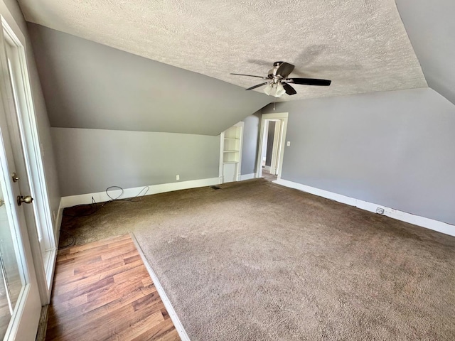 1303 W Locust St, Bloomington, IL 61701 - bonus room featuring a textured ceiling, ceiling fan, lofted ceiling, baseboards, and carpet flooring