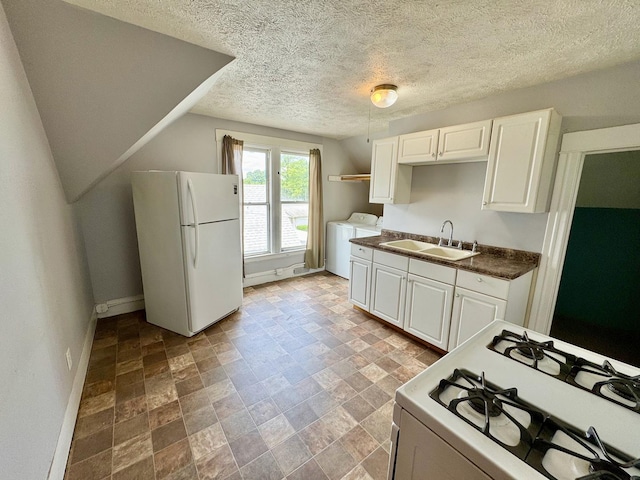 1303 W Locust St, Bloomington, IL 61701 - kitchen featuring white appliances, a sink, washer and clothes dryer, baseboards, and stone finish floors