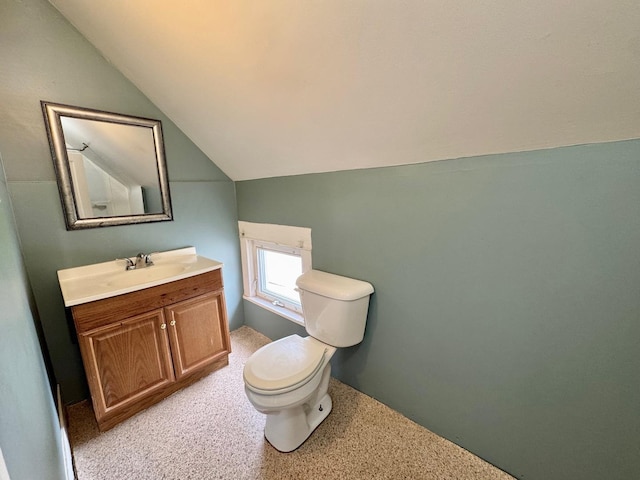 1303 W Locust St, Bloomington, IL 61701 - bathroom featuring lofted ceiling, toilet, and vanity