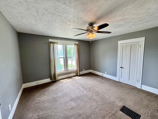1303 W Locust St, Bloomington, IL 61701 - carpeted empty room with a ceiling fan, baseboards, and a textured ceiling