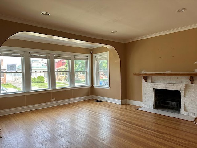 2029 S 11th Ave, Maywood, IL 60153 - unfurnished living room with arched walkways, ornamental molding, a fireplace, and wood finished floors