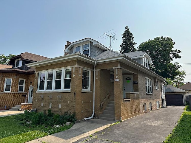 2029 S 11th Ave, Maywood, IL 60153 - bungalow-style home featuring entry steps, brick siding, a garage, a chimney, and an outbuilding