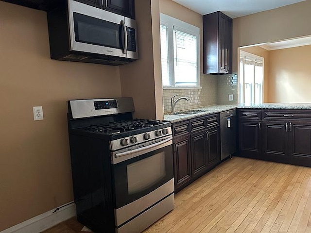2029 S 11th Ave, Maywood, IL 60153 - kitchen featuring stainless steel appliances, backsplash, light wood finished floors, and light stone countertops