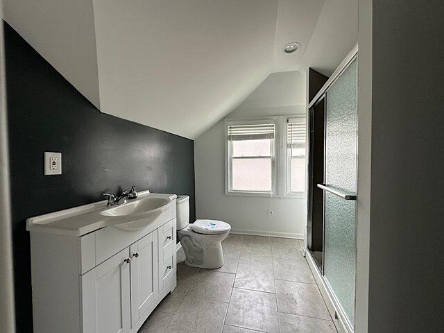 2029 S 11th Ave, Maywood, IL 60153 - full bathroom with lofted ceiling, a stall shower, vanity, and tile patterned flooring