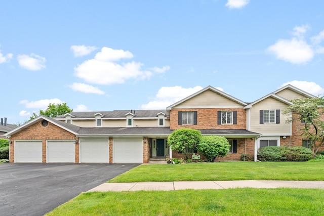 7260 S Adams St Unit C, Willowbrook, IL 60527 - view of front of property with brick siding, driveway, a front lawn, and an attached garage