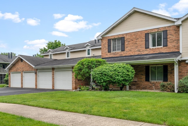 7260 S Adams St Unit C, Willowbrook, IL 60527 - view of front of house with brick siding, driveway, a garage, and a front lawn