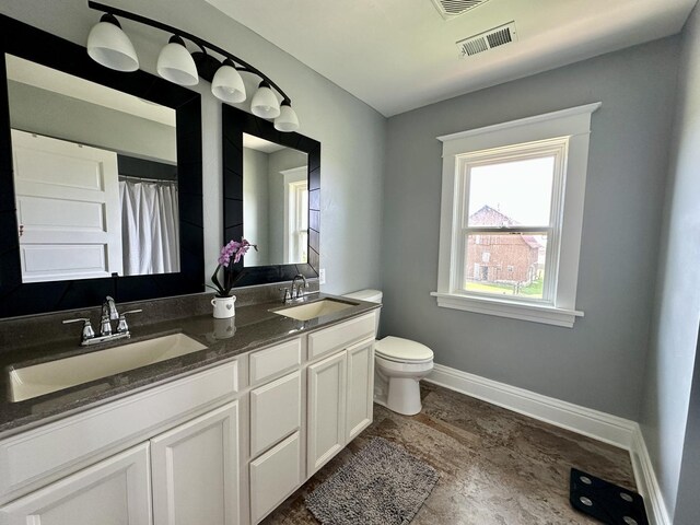 2034 Gittleson Rd, Rochelle, IL 61068 - full bathroom featuring toilet, double vanity, baseboards, and a shower with shower curtain