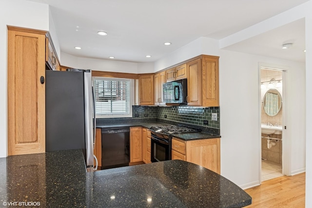 914 Meadowcrest Rd, La Grange Park, IL 60526 - kitchen with black appliances, dark stone counters, light wood-style flooring, decorative backsplash, and recessed lighting