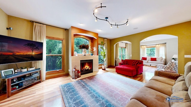 1535 S Douglas Ave, Arlington Heights, IL 60005 - living area featuring wood finished floors, arched walkways, a fireplace with flush hearth, and track lighting