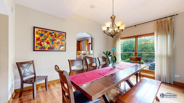 1535 S Douglas Ave, Arlington Heights, IL 60005 - dining room with arched walkways, a chandelier, light wood finished floors, and lofted ceiling