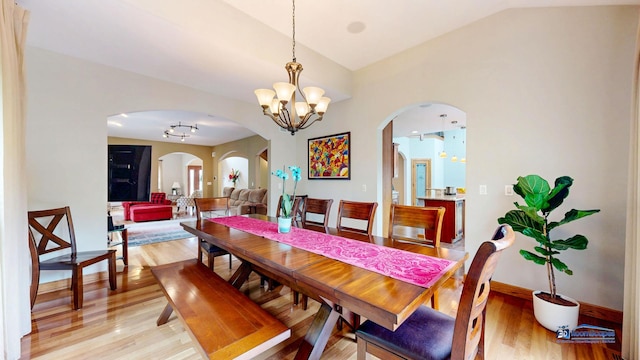 1535 S Douglas Ave, Arlington Heights, IL 60005 - dining space with light wood finished floors, arched walkways, a chandelier, and vaulted ceiling