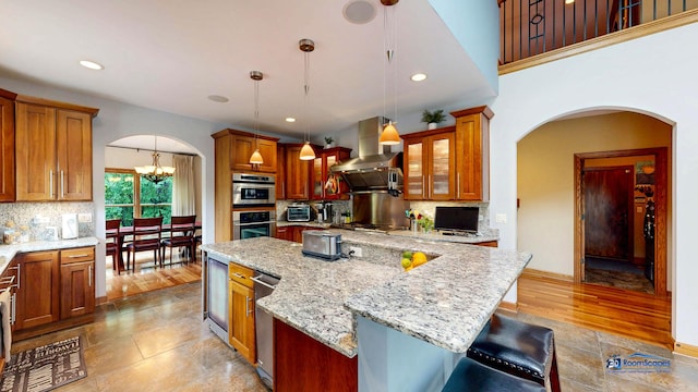 1535 S Douglas Ave, Arlington Heights, IL 60005 - kitchen with island exhaust hood, arched walkways, decorative backsplash, a center island, and recessed lighting
