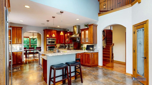 1535 S Douglas Ave, Arlington Heights, IL 60005 - kitchen featuring recessed lighting, a kitchen island with sink, tasteful backsplash, arched walkways, and wall chimney exhaust hood