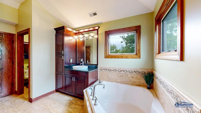 1535 S Douglas Ave, Arlington Heights, IL 60005 - bathroom with vanity, a bath, and vaulted ceiling