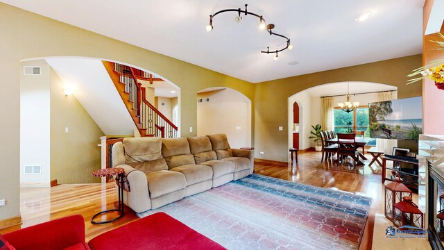 1535 S Douglas Ave, Arlington Heights, IL 60005 - living area featuring arched walkways, wood finished floors, a chandelier, and stairway