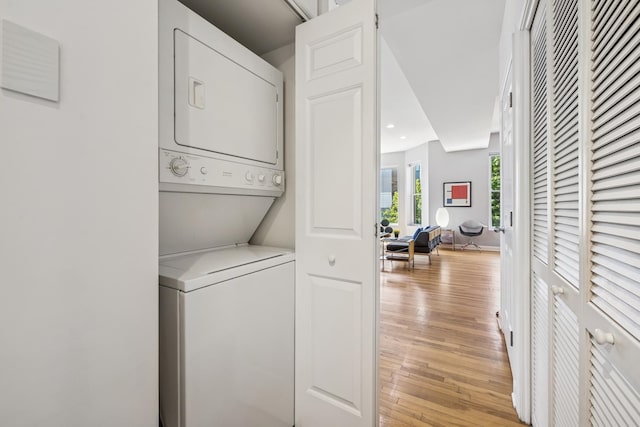 612 W Barry Ave Unit 3, Chicago, IL 60657 - laundry room with stacked washer / dryer, light wood-style floors, and recessed lighting