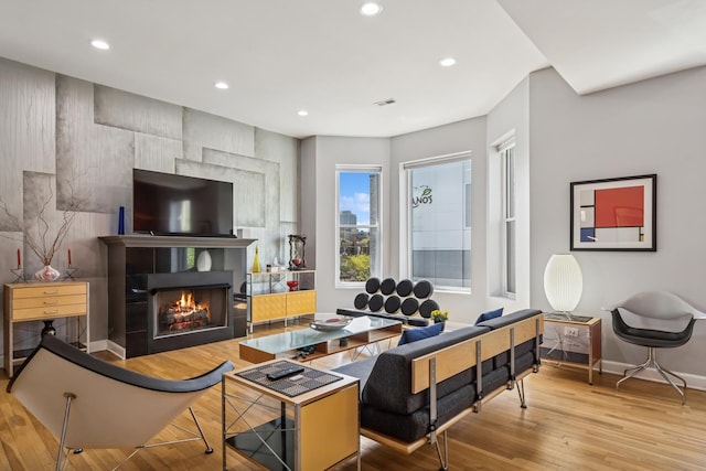 612 W Barry Ave Unit 3, Chicago, IL 60657 - living room featuring baseboards, recessed lighting, a lit fireplace, and wood finished floors
