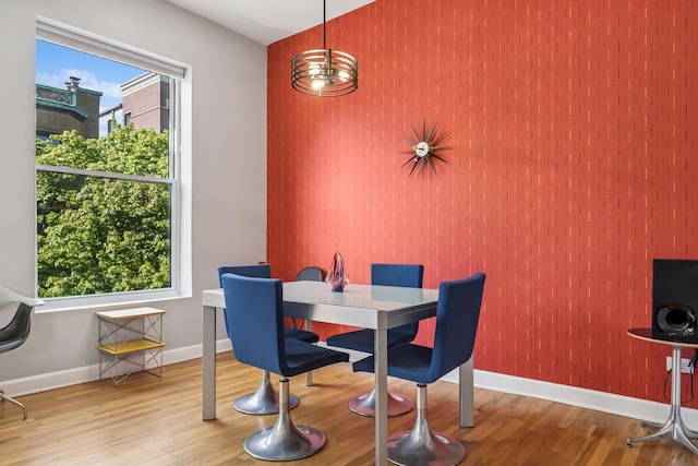 612 W Barry Ave Unit 3, Chicago, IL 60657 - dining area featuring an accent wall, wood finished floors, and baseboards